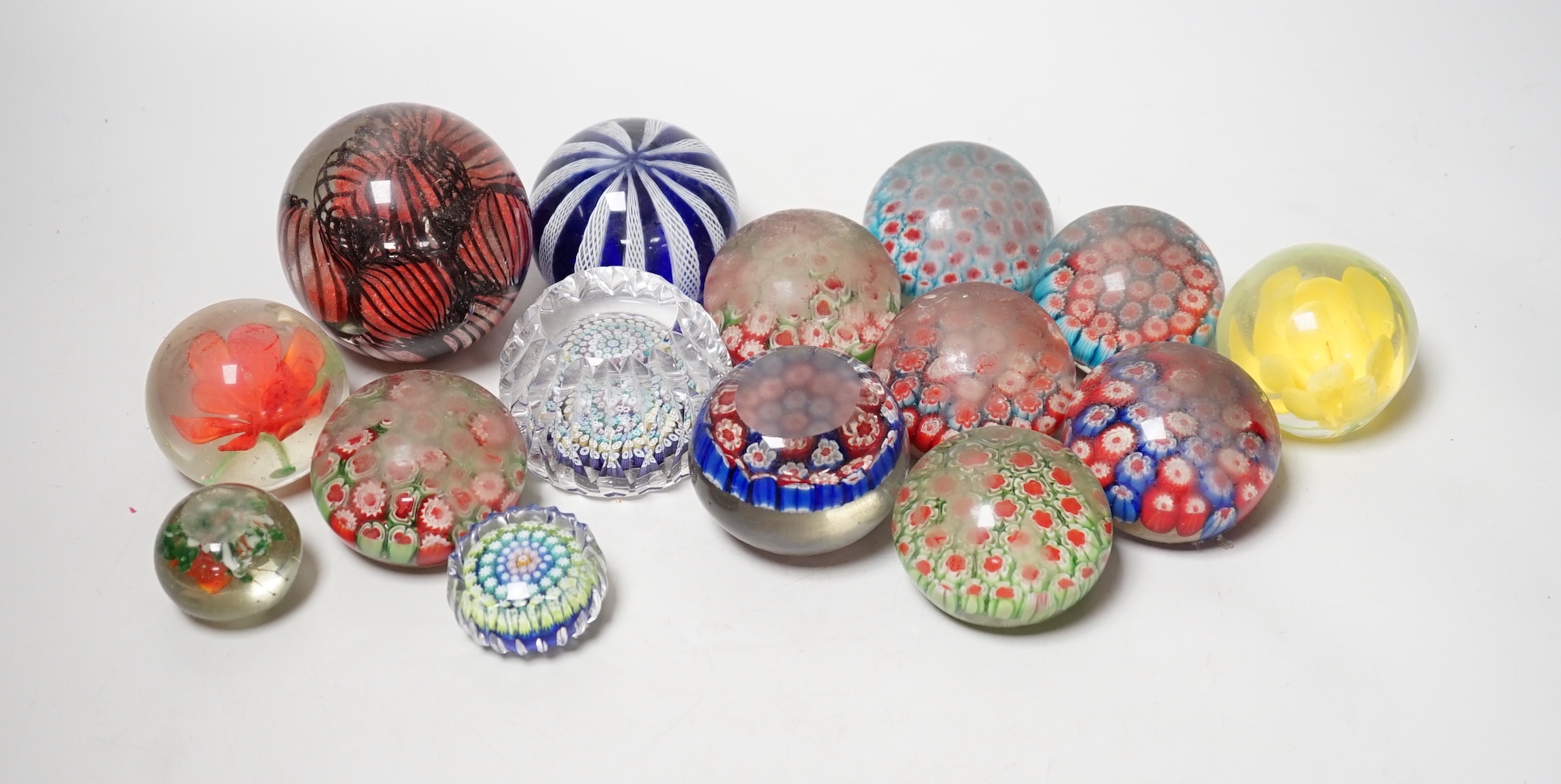 A group of assorted glass paperweights, including a Perthshire type close-packed millefiori paperweight